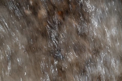 Close-up of moving water with a pattern of light and shadow, light trails, long exposure, North