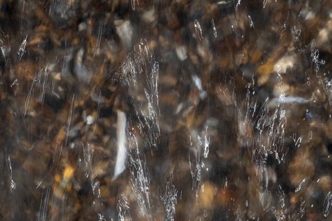 Close-up of moving water with a pattern of light and shadow, long exposure, North Sea, Denmark