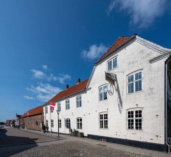 White historic buildings on a cobbled street, Old Town, Ringkøbing, Ringkøbing Fjord, Denmark