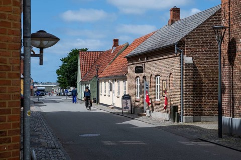 Street with historic brick houses and cyclists, Old Town, Ringkøbing, Ringkøbing Fjord, Denmark