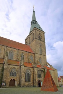 Romanesque St Andrew's Church and Sculpture of the Word, rusty steel sculpture with words, pyramid,