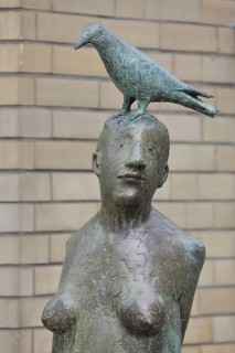 Sculpture Standing with bird by Karl Ulrich Nuss 1997, nude female figure with dove on her head,
