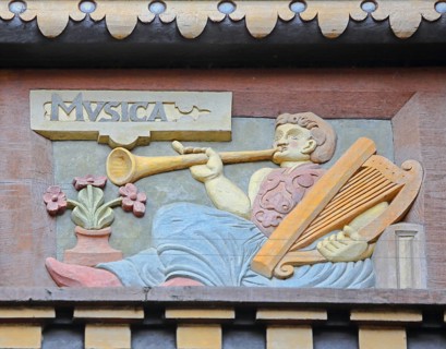 Allegorical woodcarving with figure for music with hand harp, flute and trumpet, lyre, lyre,