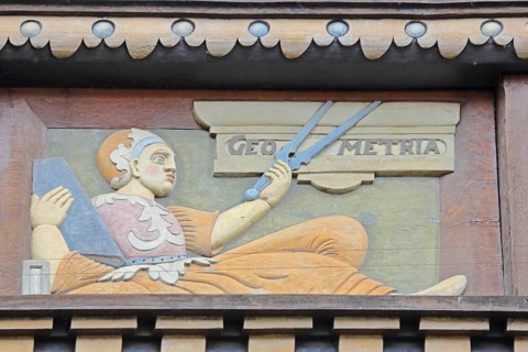 Allegorical woodcarving with figure for geometry with compass, geometric, measured, measurement,