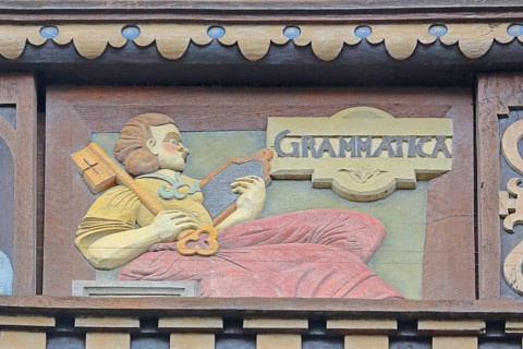 Allegorical woodcarving with figure grammar, key, plaque, spelling, linguistics, language,