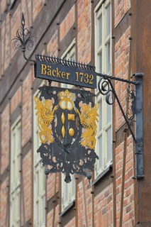Nose plate with golden date 1732 on the brick house, half-timbered house, window, wrought-iron
