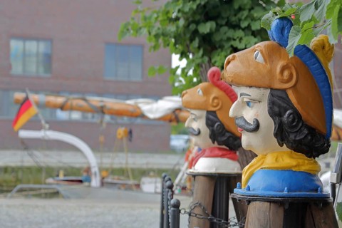 Colourful Swedish heads as landmarks, historical wooden head with face and four eyes, Swedish head
