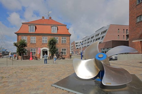Baroque tree house with ship's propeller, brick building, tourists, Old Harbour, Wismar,