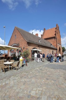 Historic water gate as part of the former town fortifications, street pub, restaurant, pedestrian,