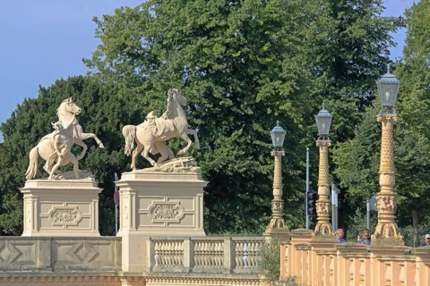 Castle bridge with two horse figures, street lamps, river bank, balustrade, Schwerin,