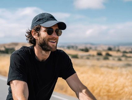 A man rides a bicycle and smiles in a friendly manner, AI generated, AI generated