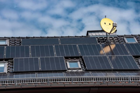 Residential building with photovoltaic modules on the roof, North Rhine-Westphalia, Germany