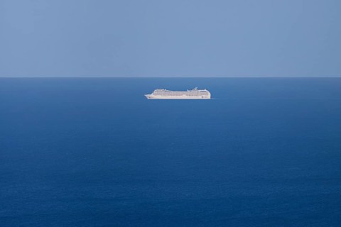 A cruise ship passes near the Costa Rei on the Mediterranean Sea near Sardinia, Monte Nai, Costa