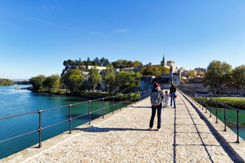 Strollers on the Pont Saint Benezet, Pont d'Avignon, Avignon Cathedral, Avignon, Vaucluse, France