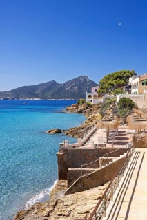House on the seashore of the blue Mediterranean Sea on a sunny summer day, Sant elm, Mallorca,