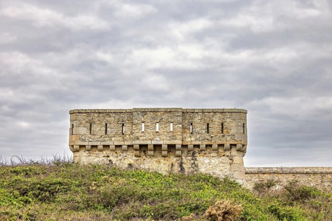 Old fort tower at Pointe du Toulinguet with a cloudy sky, Camaret-sur-Mer, Crozon peninsula,