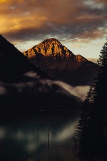 Sunrise with reflections and alpenglow in Lake Heiterwanger See in Tyrol in the Alps in Austria