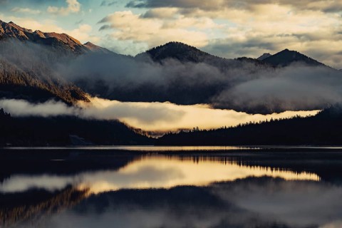 Sunrise with reflections and alpenglow in Lake Heiterwanger See in Tyrol in the Alps in Austria