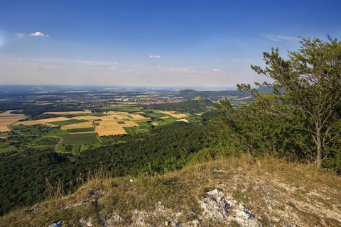 Sweeping view from the Breitenstein rock plateau over fields and hills under a clear sky, Bissingen