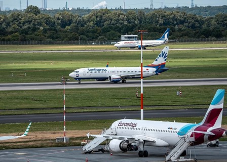 Düsseldorf Airport, Eurowings Airbus aircraft on the apron, SunExpress Boeing 737 on take-off,