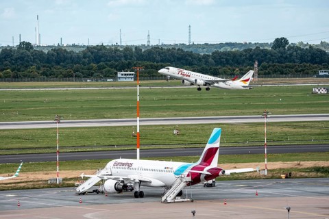Düsseldorf Airport, Eurowings Airbus aircraft on the apron, German Airways Embraer ERJ-190 taking