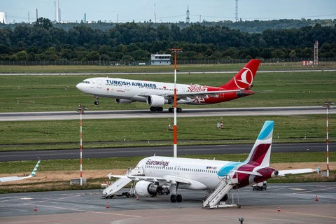 Düsseldorf Airport, Eurowings Airbus aircraft on the apron, Turkish Airlines Airbus A330-200 taking