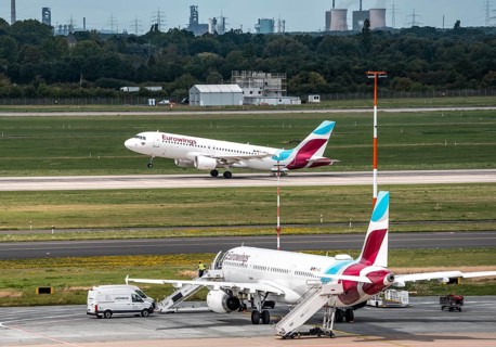 Düsseldorf Airport, Eurowings aircraft taking off, Eurowings Airbus on the apron, skyline of the