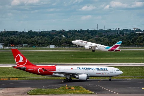 Düsseldorf Airport, Eurowings Airbus on take-off, Turkish Airlines Airbus A330-200 on the taxiway