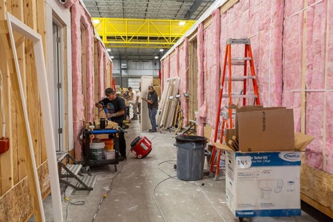Romulus, Michigan - Workers build apartments in Ginosko Modular 's factory using modular