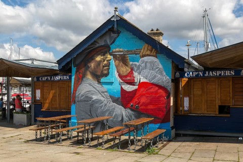 Pirate mural painted on wall at Cap'n Jaspers cafe, The Barbican, Plymouth, Devon, England, UK