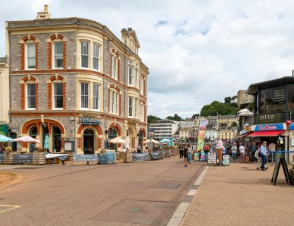 Offshore bar and restaurant, people walking near quayside shops, Vaughan Parade, Torquay, Devon,