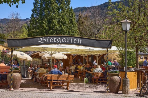 Beer garden, entrance, outdoor area of a restaurant with parasols, tables and benches, lantern,