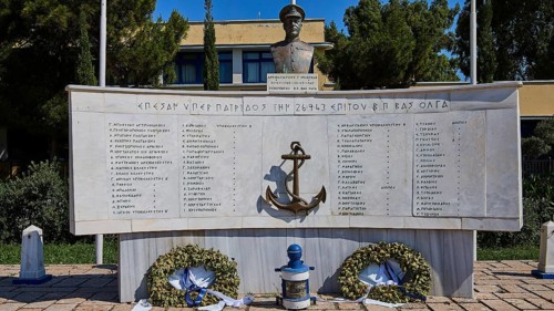 A monument with bust and anchor in the centre, surrounded by plaques with inscriptions and wreaths,