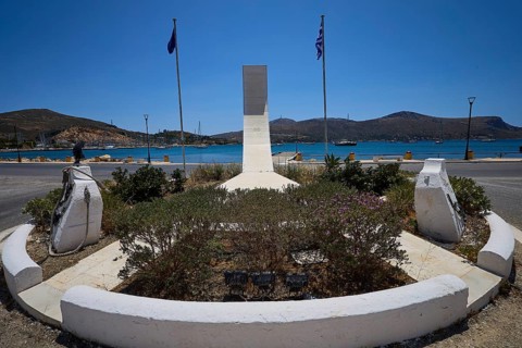 War memorial, A memorial with geometric shape, two flags and view of the sea and mountains, photos