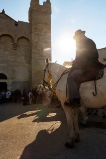 Guardian of the Camargue, rider on Camargue horse in front of the church, sunbeams, pilgrimage,