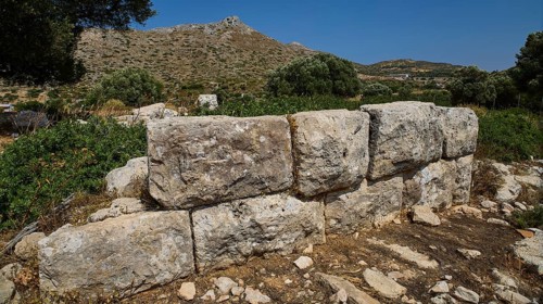 Monumental stone blocks form a wall in a mountainous, naturally beautiful setting, Artemis Temple,