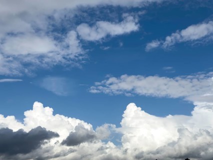 Below grey white stratocumulus clouds, middle above stratocumulus above altostratus in front of