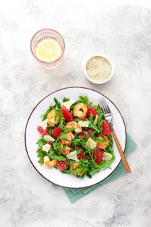 Fresh shrimp salad with arugula, grapefruit, and parmesan served in a bowl