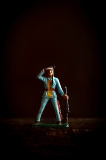 Intricate Native American Indian figure toy figurine in a blue uniform confidently salutes while
