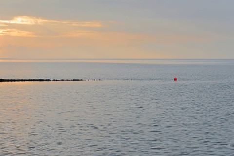 Evening mood at the Wadden Sea, stone groyne with red buoy, North Sea, Norddeich, Lower Saxony,