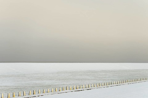 Winter day, onset of winter, snow-covered dyke and boundary piles, North Sea, Norddeich, Lower