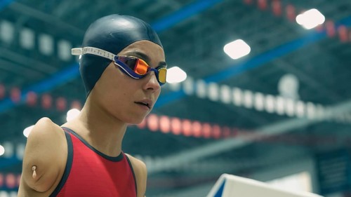Amputee swimming in an Olympic pool