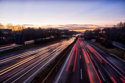 Motorway A96 at dusk and night with coloured lanes of moving cars. Munich, Bavaria, Germany