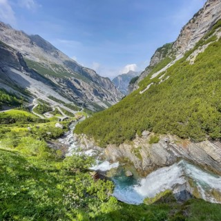 View of the Cascata dello del Braulio waterfall on the right foreground, in the background southern