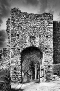 Léotoing village. An old stone archway showcases weathered stones and intricate designs, Haute