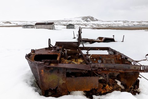 Former research station, rusty vehicle, wooden hut, Kinvika, Muchinsonfjord, Spitsbergen, Svalbard