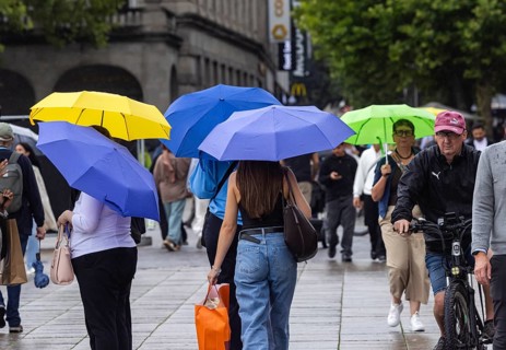 Rainy weather in Stuttgart. People with umbrellas hurry through the rain on Königstraße. Stuttgart,