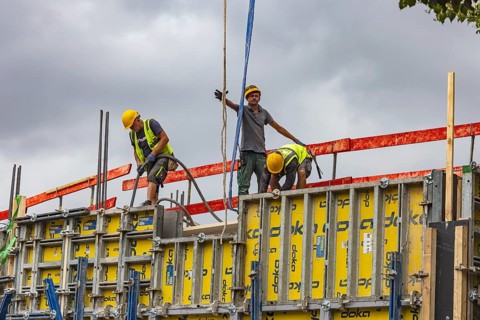 Construction worker concreting a wall. Construction site for an apartment block in Stuttgart,