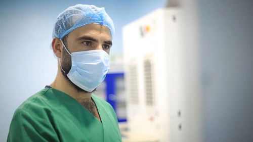 A patient and surgeon in the operating room during ophthalmic surgery