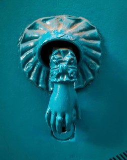 This unique door knocker features a lion's paw design with detailed craftsmanship. Its turquoise